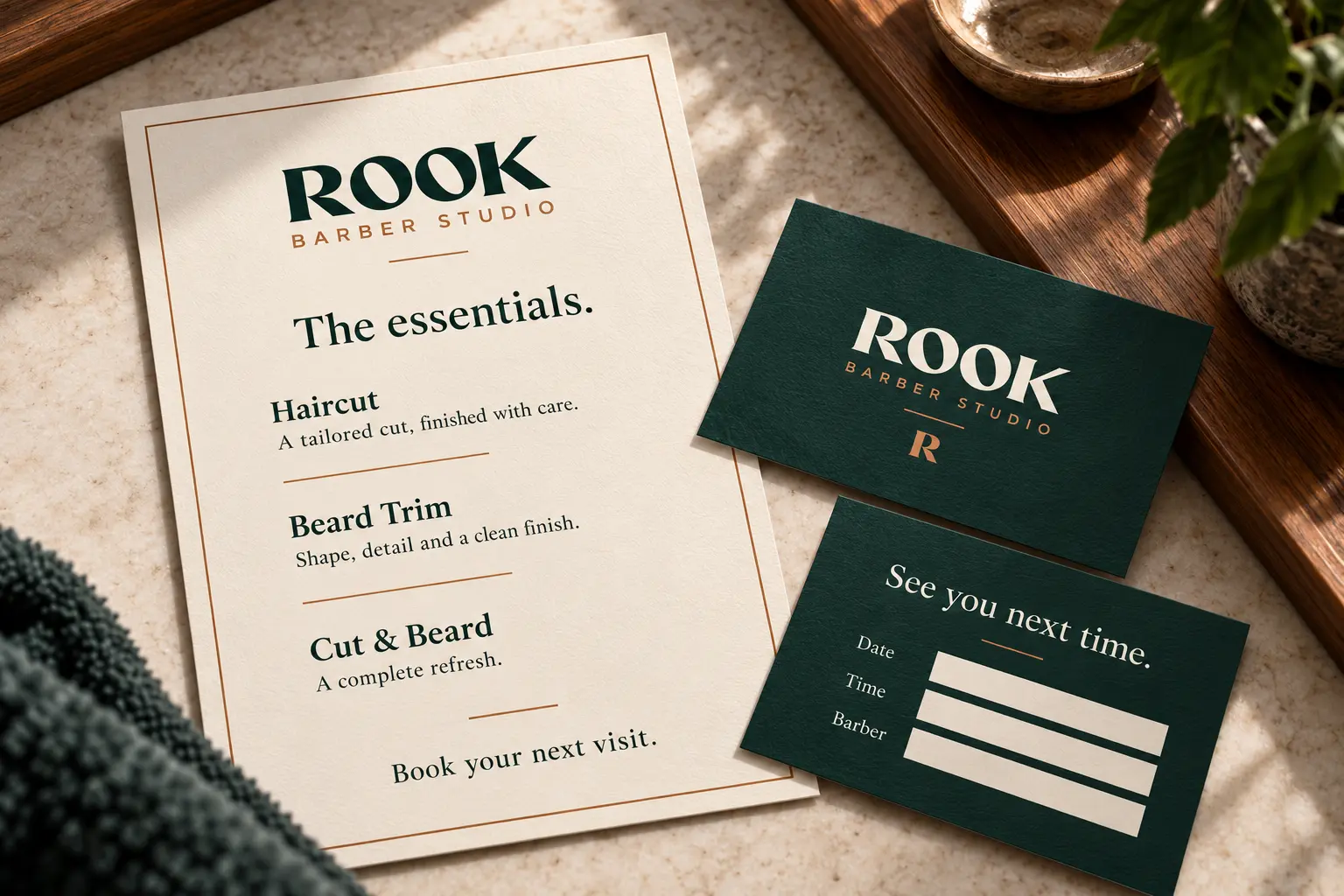 Rook Barber Studio printed service menu and appointment card design in ivory and forest green